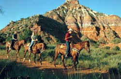 Riding horses in Palo Duro Canyon.