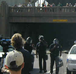 A swat team arrives from under the triple underpass.