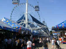 Walking along the Texas State Fair Midway with the Texas Skyway above and the Texas Star Ferris Wheel in the distance.
